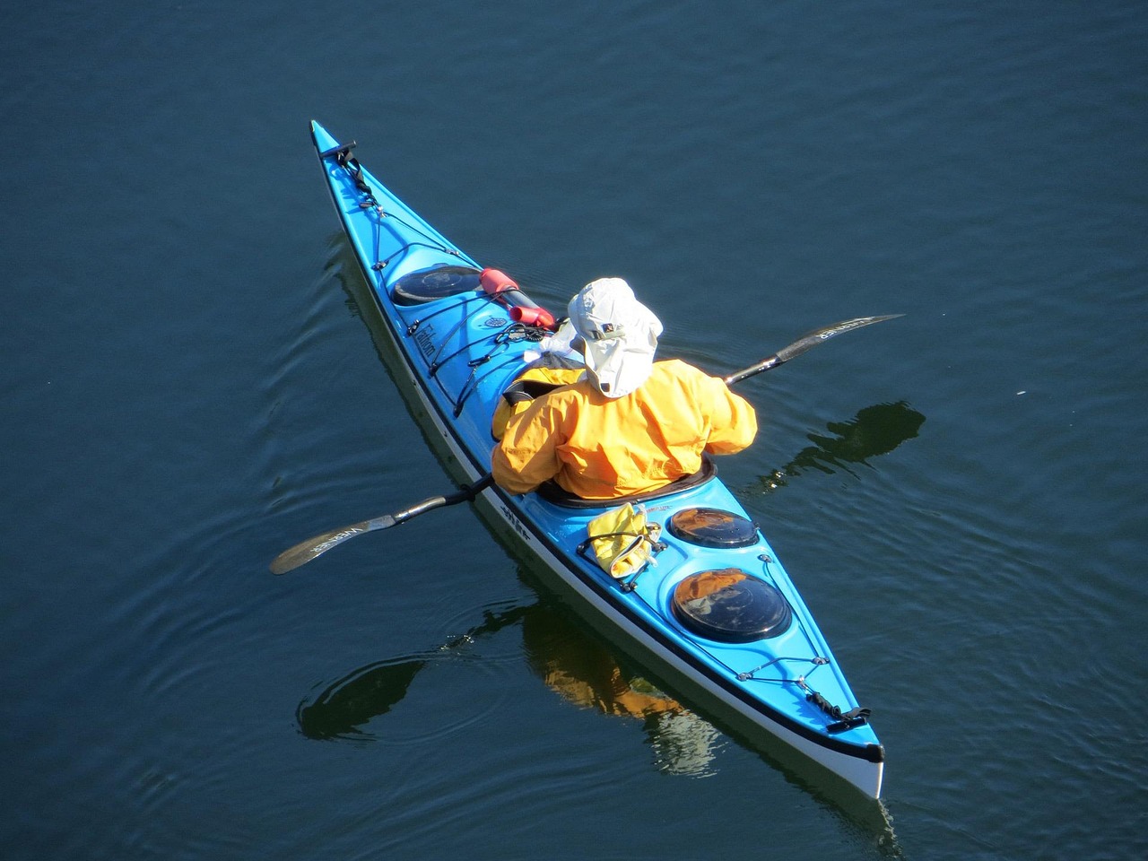 kayaker paddling lake kayaker paddling lake